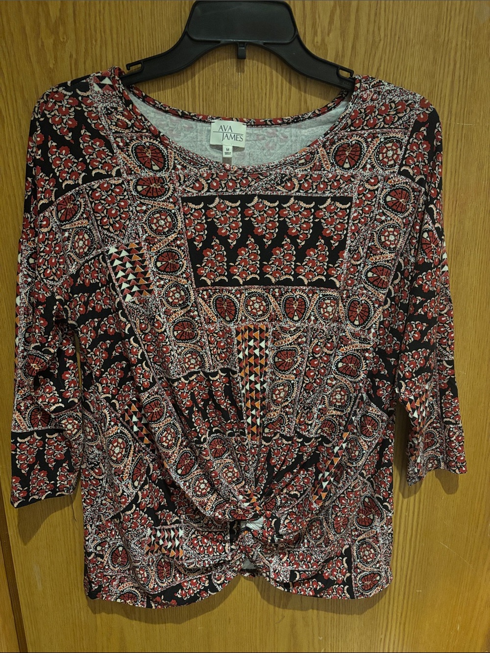 AVA JAMES, 3/4” sleeve knotted blouse 
Brick red, orange and black, Medium